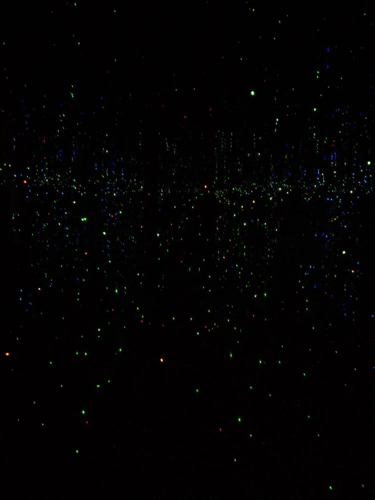 Speckled lights, dancing through darkness 