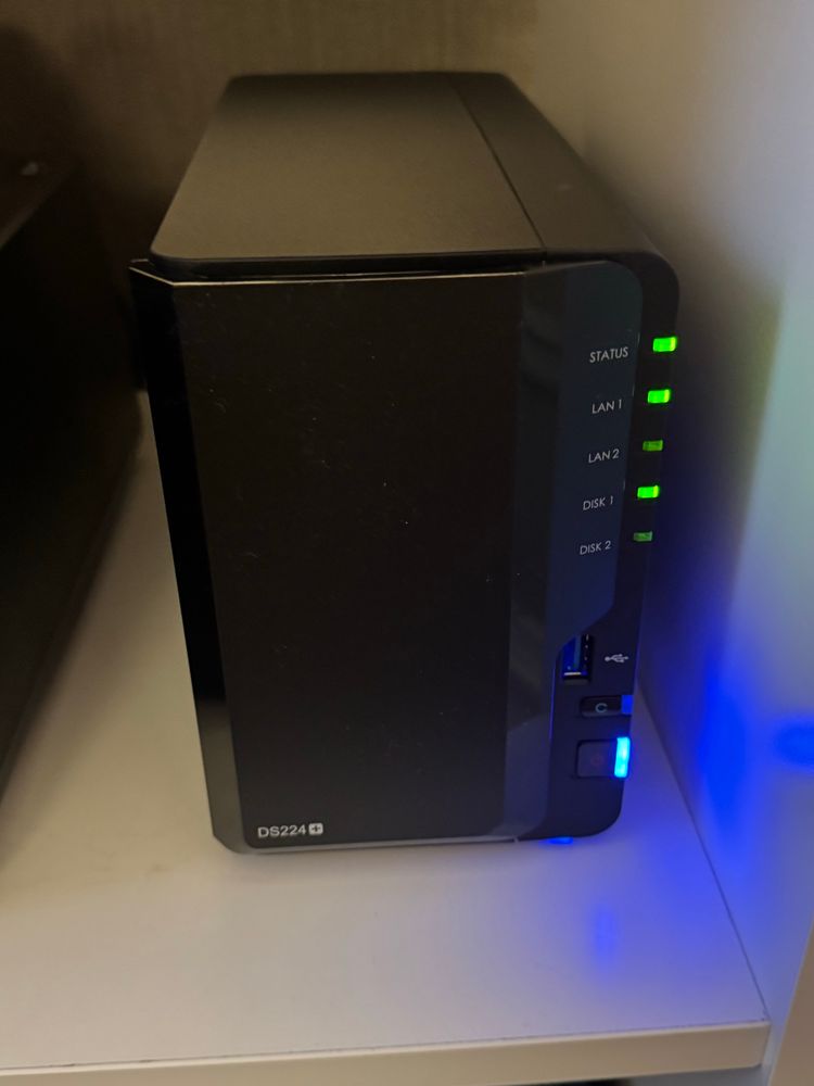 A Synology DS224+ NAS drive with status lights blinking