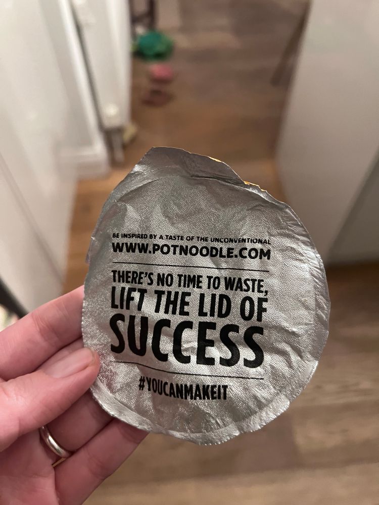 The image shows the under side of a pot noodle lid. The copy on the lid reads, “there’s no time to waste, lift the lid of success #youcanmakeit”
