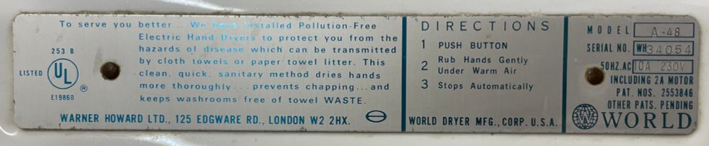 A World Dryer label on a hand dryer that says, "To serve you better. We have installed Pollution-Free Electric Hand Dryers to protect you from the hazards of disease which can be transmitted by cloth towels or paper towel litter. This clean, quick, sanitary method dries hands more thoroughly, prevents chapping, and keeps washrooms free of towel WASTE.