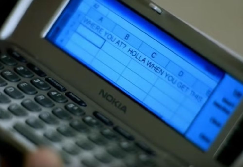 Screenshot from Nelly's Dilemma music video.  Depicts a Nokia device with Excel on the screen.  Cell A1 contains the words "WHERE YOU AT? HOLLA WHEN YOU GET THIS" as though this is a means to text message someone.