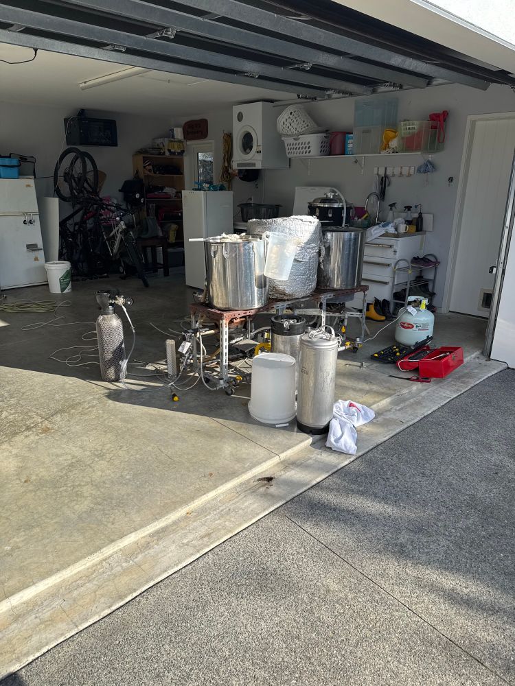 A brew kit setup with three pots and a fermenter 