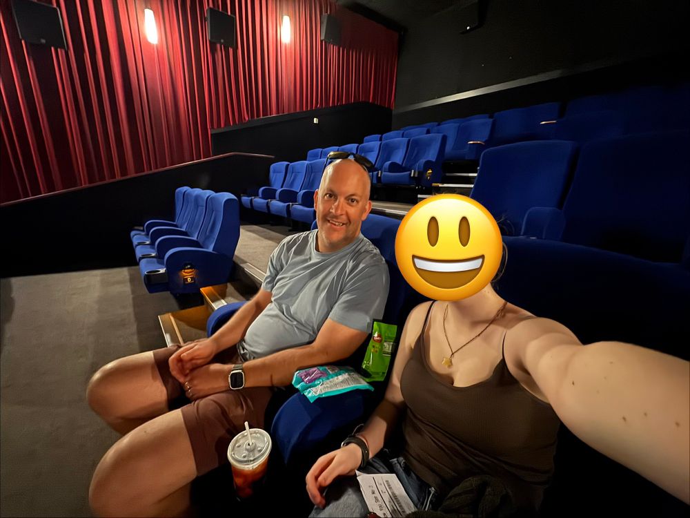 A photo of my daughter and I in an empty cinema waiting for the movie to start. 