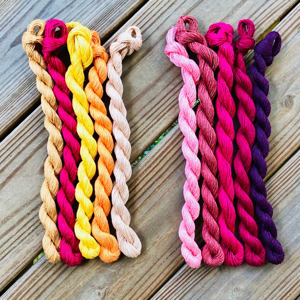 The two mini-skein sets of Louet Euroflax I got from Modern Daily Knitting. There are two sets of five colors each. On the left is beige, saturated dark pink, yellow, pale orange, and ecru. On the right, various pinks (including the maroon-y beige-y yarn from the second sunburst) and a dark purple.