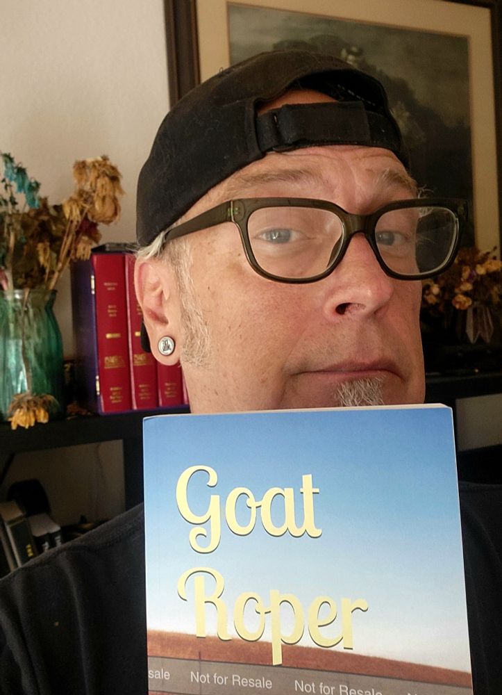 DM Pelley holding up a copy of his book "Goat Roper," and looking a bit smug I must say.