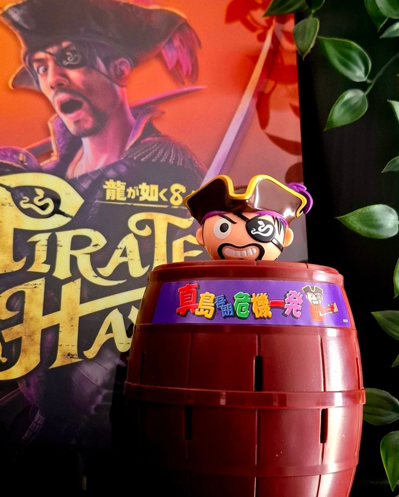 Pop-up Pirate game with Captain Majima in place of the traditional pirate. Situated in front of an acrylic block featuring the Pirate Yakuza key art.