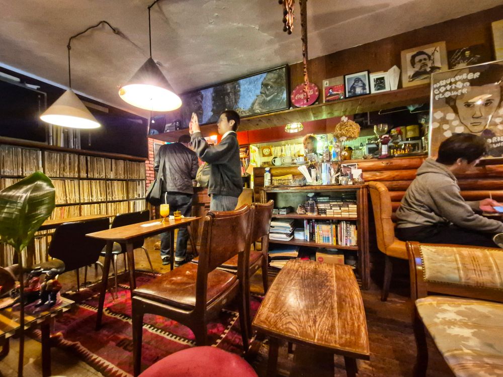 A jazz listening cafe with a wall of LPs and 2 giant speakers.