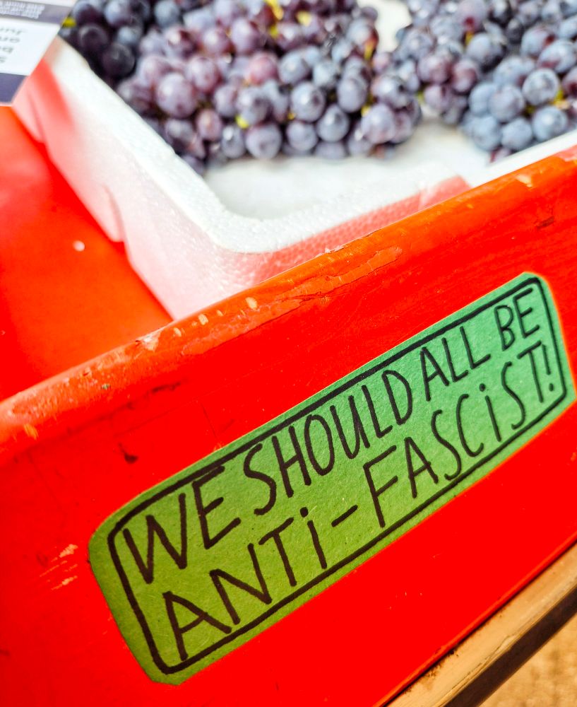 A sticker on a fruit stall reads:
We should all be anti-fascist!