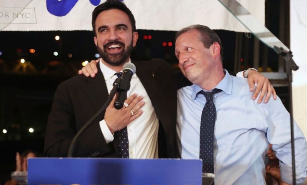 Zohran Mamdani and Brad Lander with their arms around each other during Zohran’s victory speech.