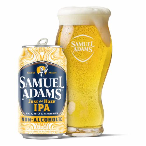 Sam Adams Just the Haze Non-Alcoholic IPA can next to a Sam Adams glass.