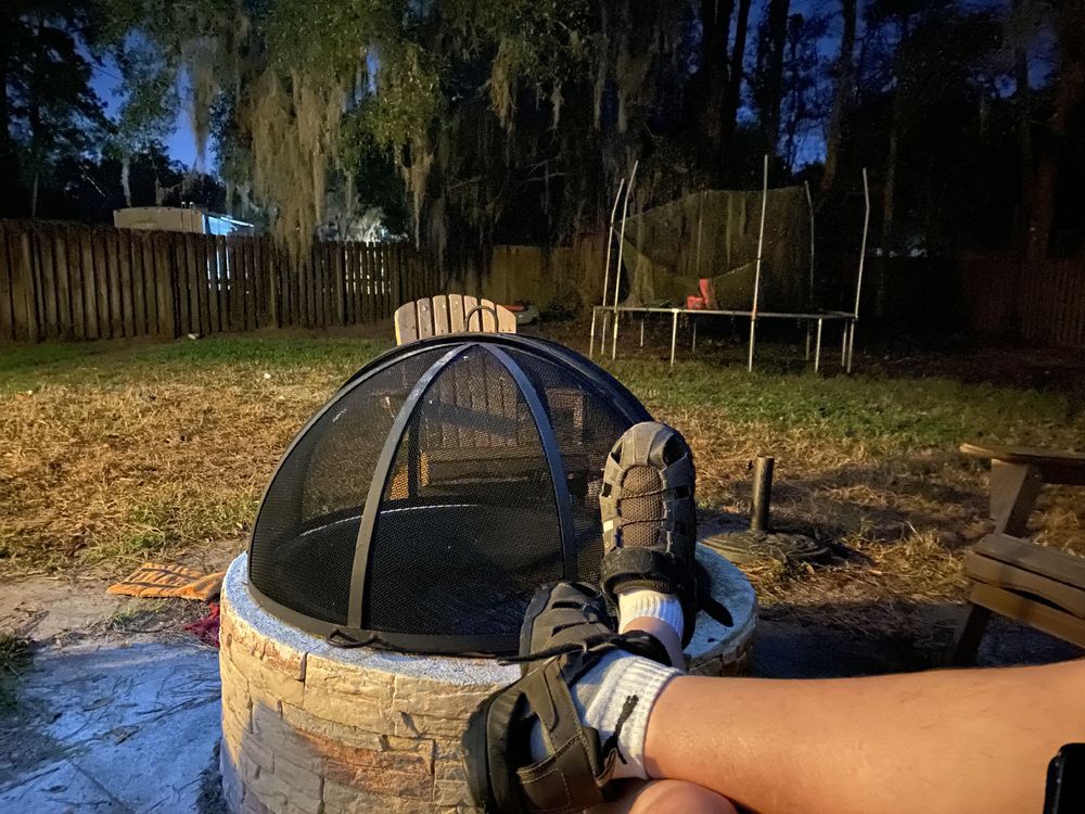 Feet up on a unlit fire pit