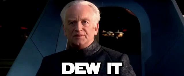 a man in a suit is sitting in a chair with the words `` dew it '' written on it .