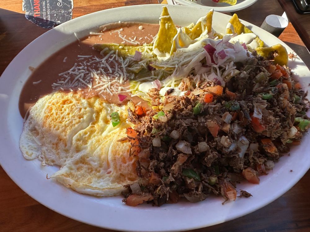 Chilaquiles, machaca, fried eggs and refried beans. Cafe de olla not pictured but enjoyed.