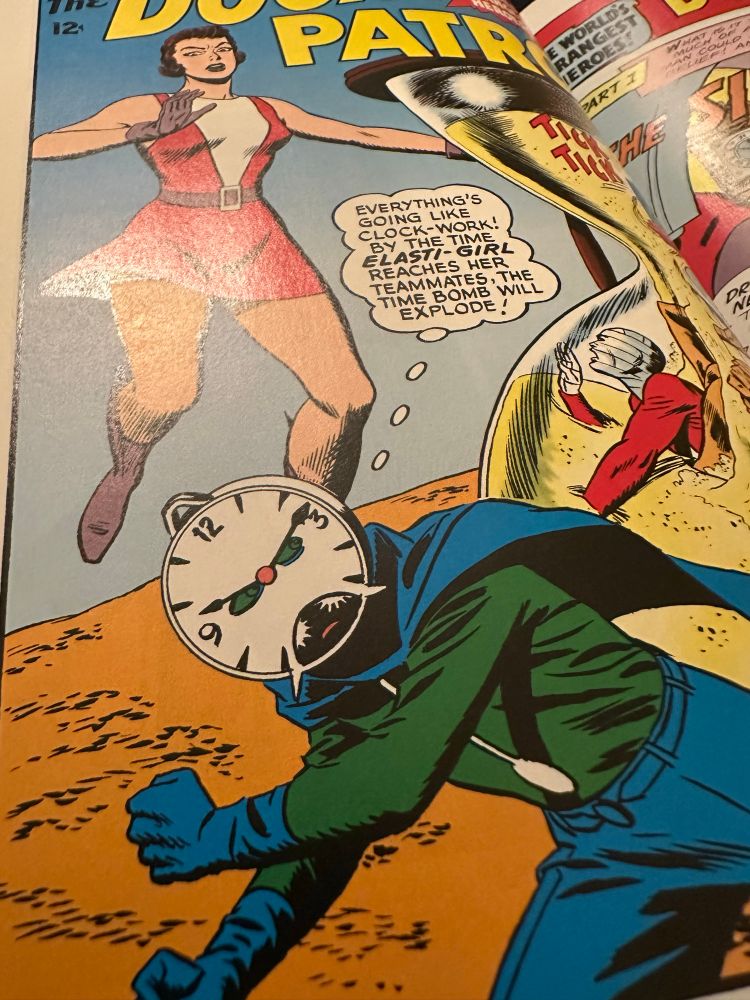 A villain with a clock for a face tries to destroy the Doom Payrol. Art by Bruno Premiani.