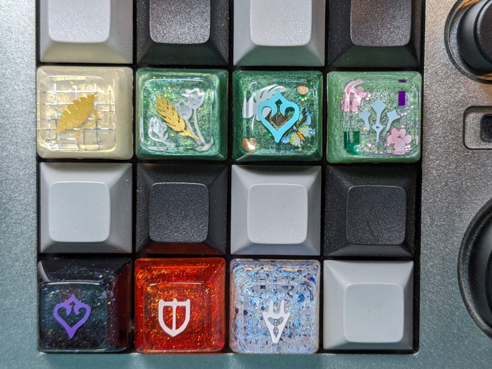 An assortment of handmade resin keycaps that are FFXIV themed. These ones are SA profile.