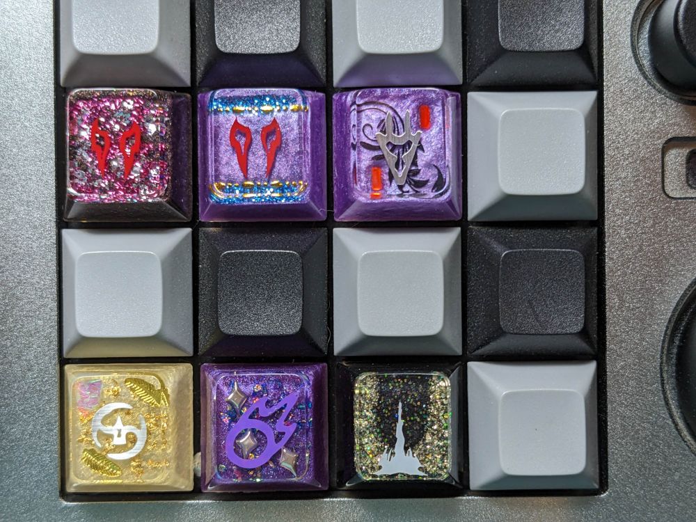 An assortment of handmade resin keycaps that are FFXIV themed. These ones are Cherry profile.