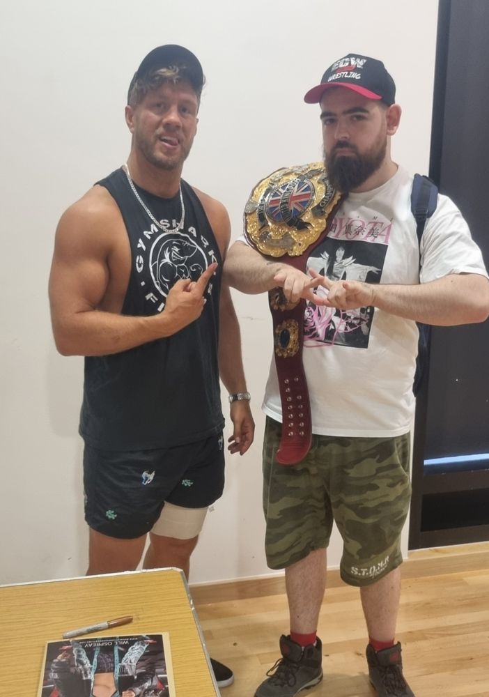 Me holding the IWGP UK Championship with Will Ospreay.