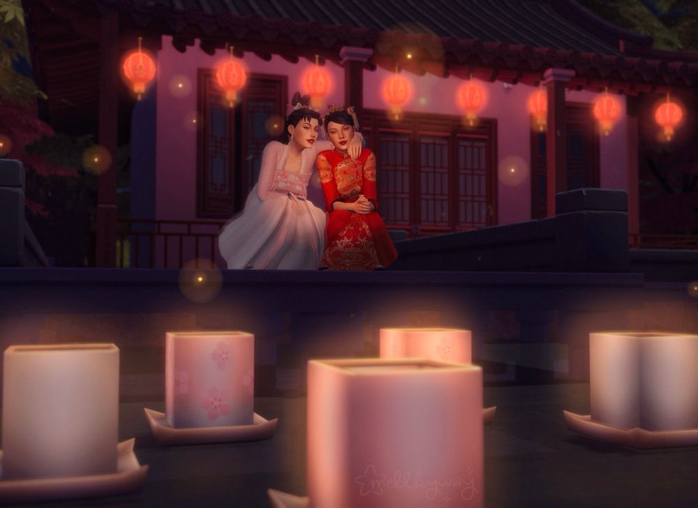 Edited photo of Marie and Ann watching some lanterns float in the water. They’re crouched on the edge of the cement and Marie’s arm rests over Ann’s shoulders. There are five lanterns, varying in color (pink, white, and pink gradient with cherry blossom pattern). There are (lucky number!!) eight lanterns hanging along the roof of the building behind them. They’re also surrounded by fireflies! 