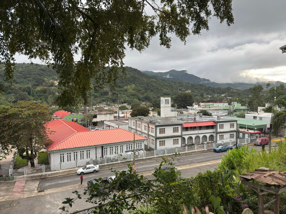 picture of part of the rainy downtown Juyaya area, and the mountains in the background with fog topping some of them 