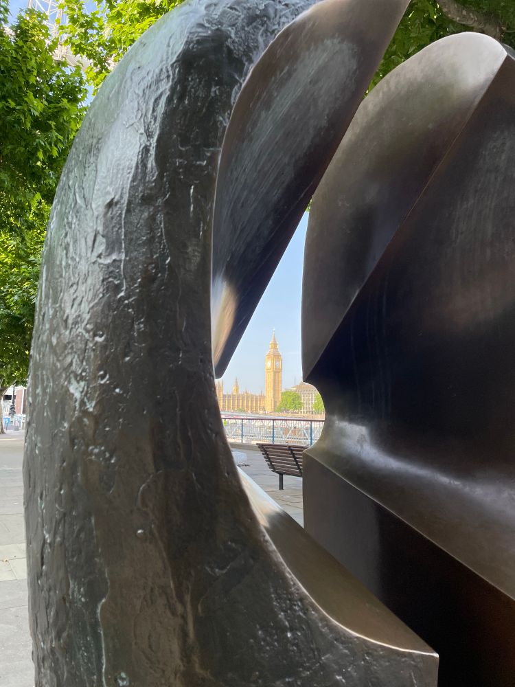 The Houses of Parliament, glimpsed through a sculpture on the south bank.