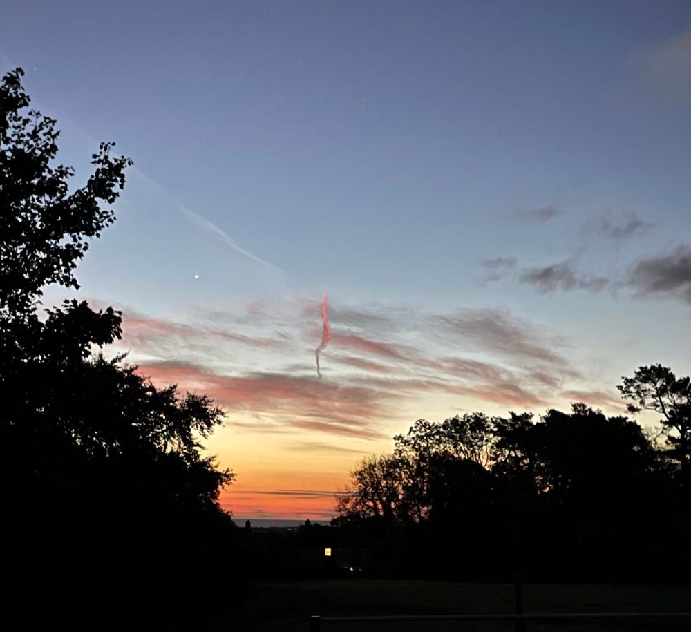 Sunrise over the sea, including a funnel cloud