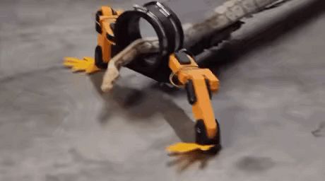 a snake is crawling on a robotic leg .