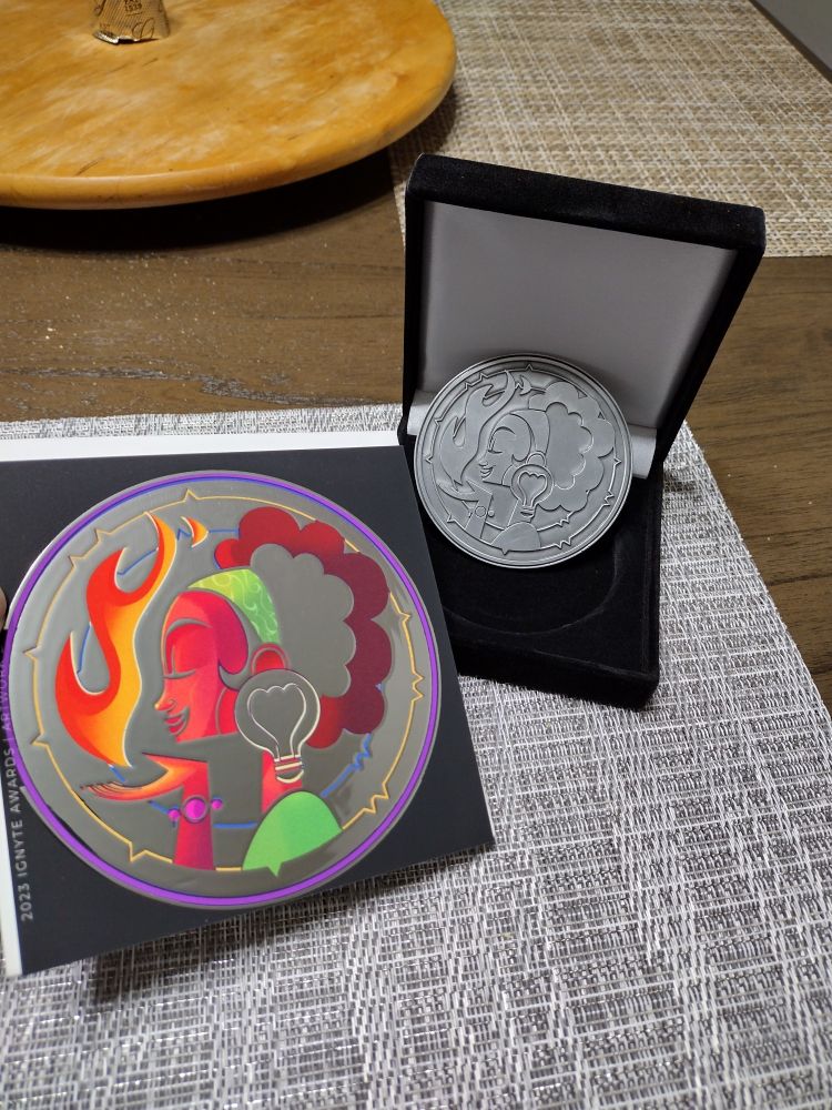 Front of Ignyte Awards coin and notification card