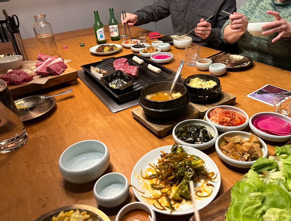 A photo of a large Korean barbecue meal