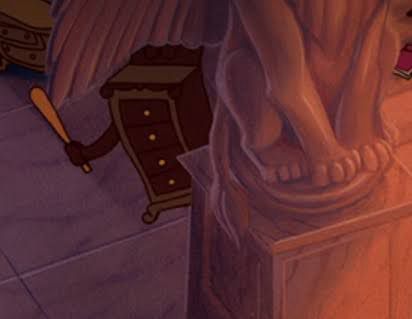 A screenshot from ‘Beauty and the Beast’ in which a chest of drawers hides behind a statue, holding a baseball bat, waiting to beat up a villager
