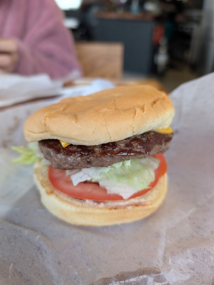 "Giant Burger" comprised of a 1/3lb burger patty, lettuce, onion, tomato on a fresh savory bun