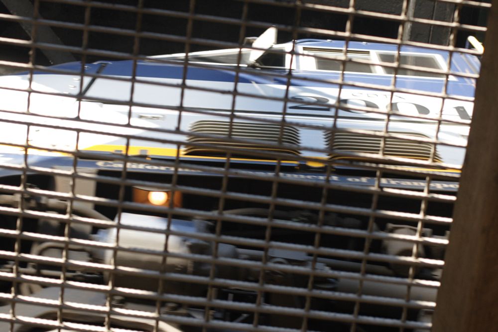 Looking up at an Amtrak train viewed through a grate