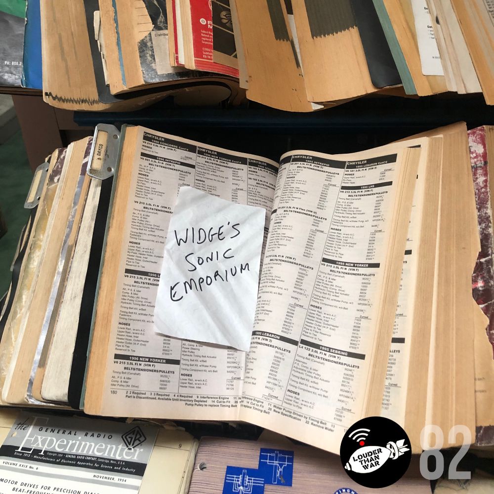 Big, dog-eared catalogs of car and radio parts, sitting open. On the middle of one, a piece of paper with WIDGE’S SONIC EMPORIUM scrawled on it in black Sharpie. In the lower right, the Louder Than War Radio logo and the number 82, which is the episode number.