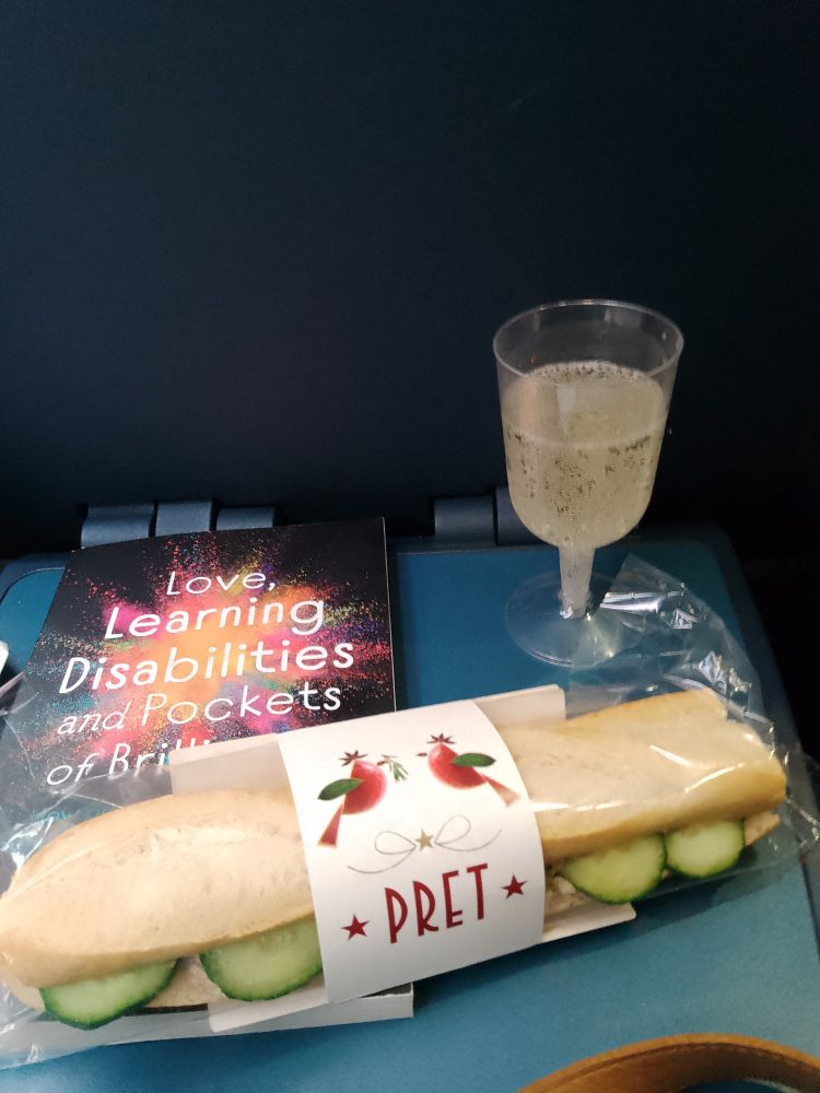 Glass of fizz, roll from Pret and Love, Learning Disabilities and Pockets of Brilliance book.