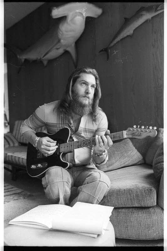 Steve Cropper plying a telecaster on a couch