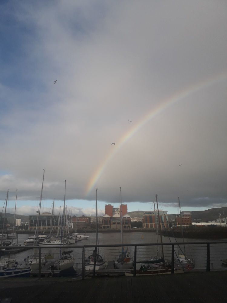 A photo of a rainbow at a marina in Belfast, Northern Ireland