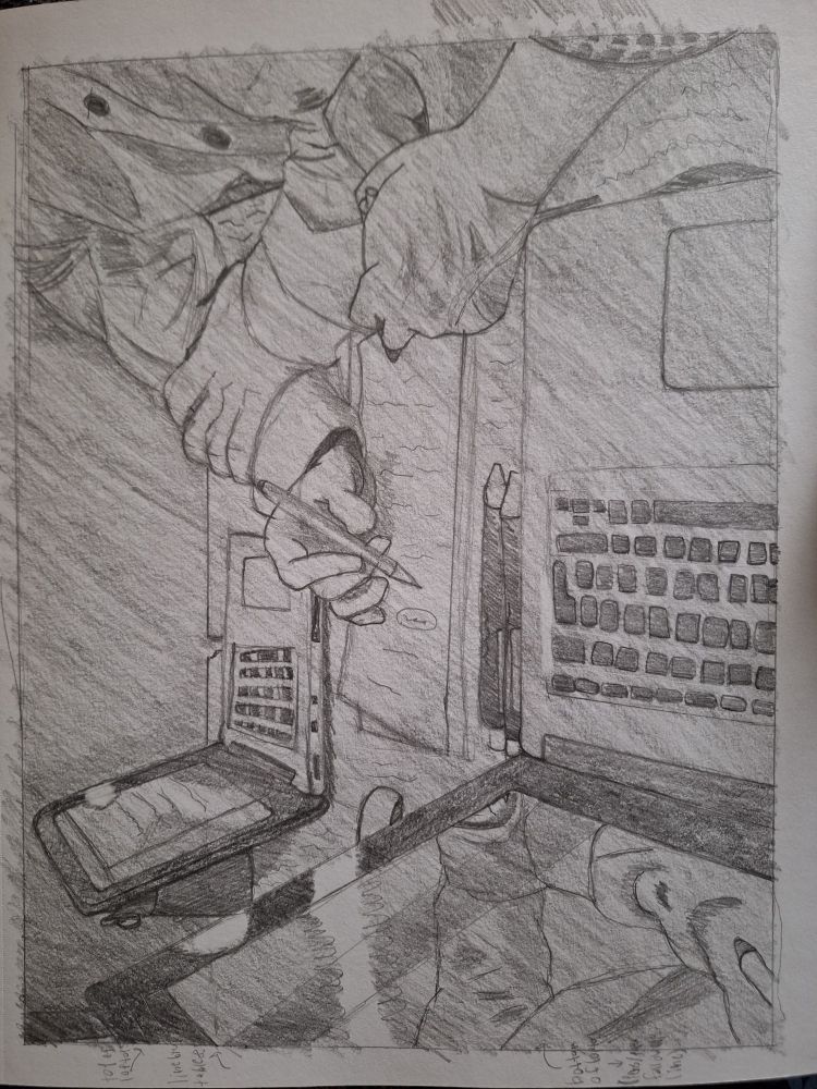 Two dudes sitting at a desk overlooking some work