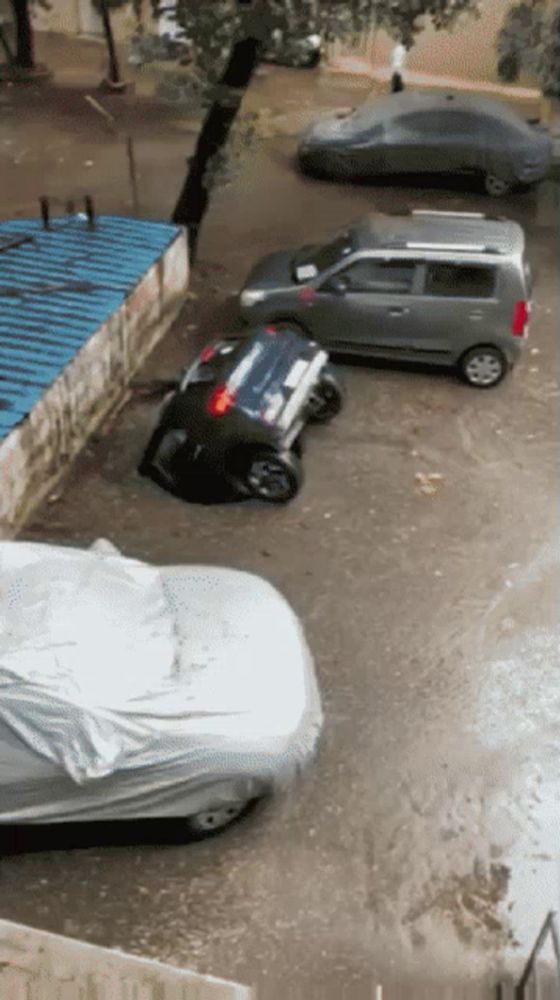 several cars are parked on a flooded street