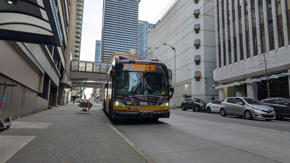 A trolleybus in downtown Seattle with route sign "7 Prentice St". It is daytime 