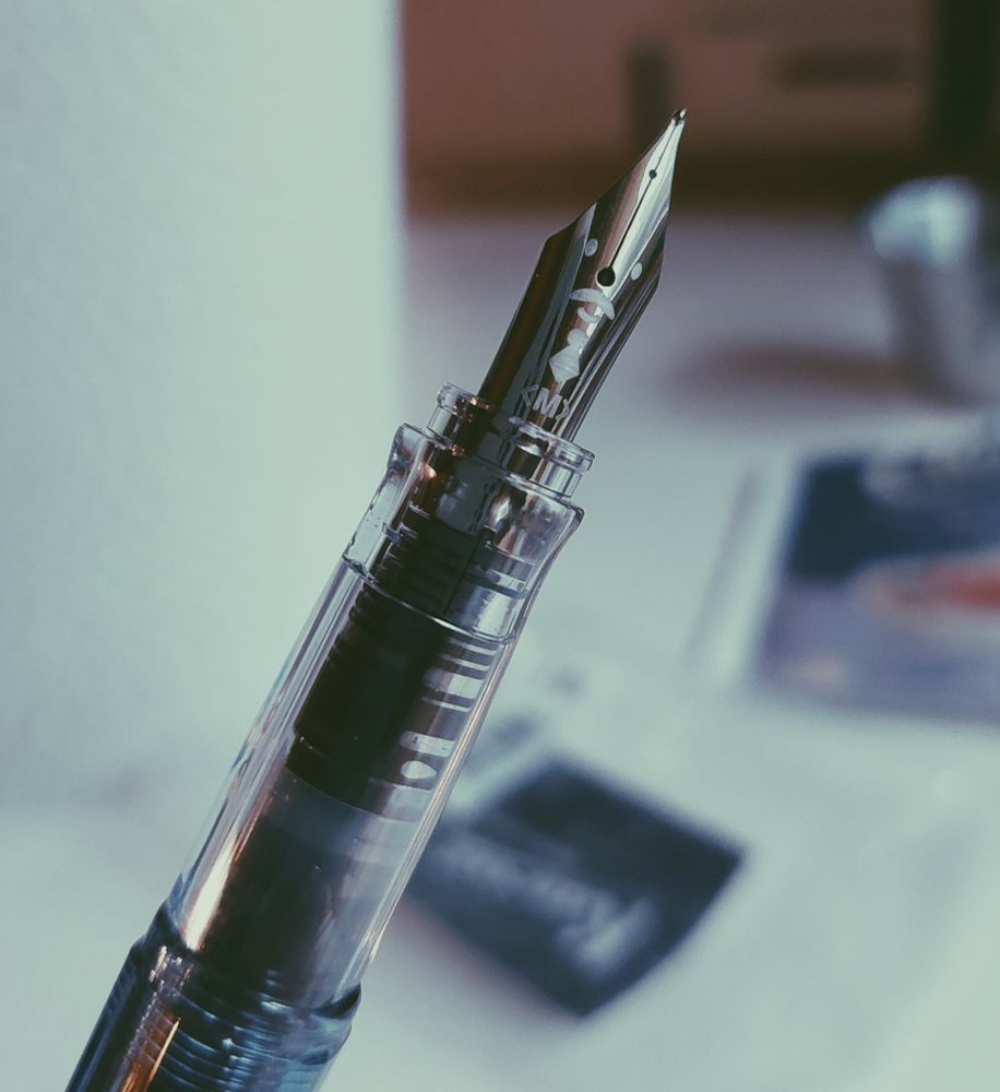 the pen tip got face w tie and mustache carved on it...