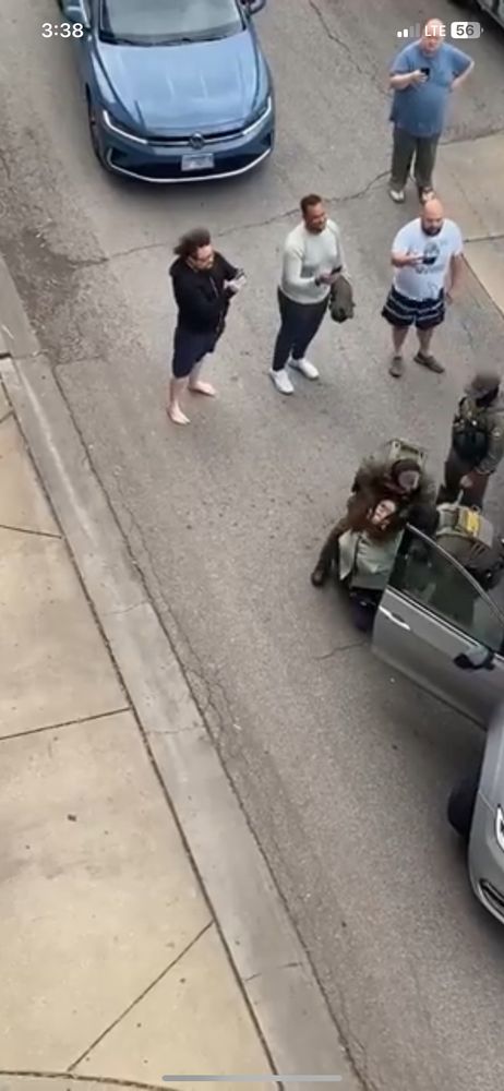 Ice agents with his hands around a WGN news producer/videographers neck 