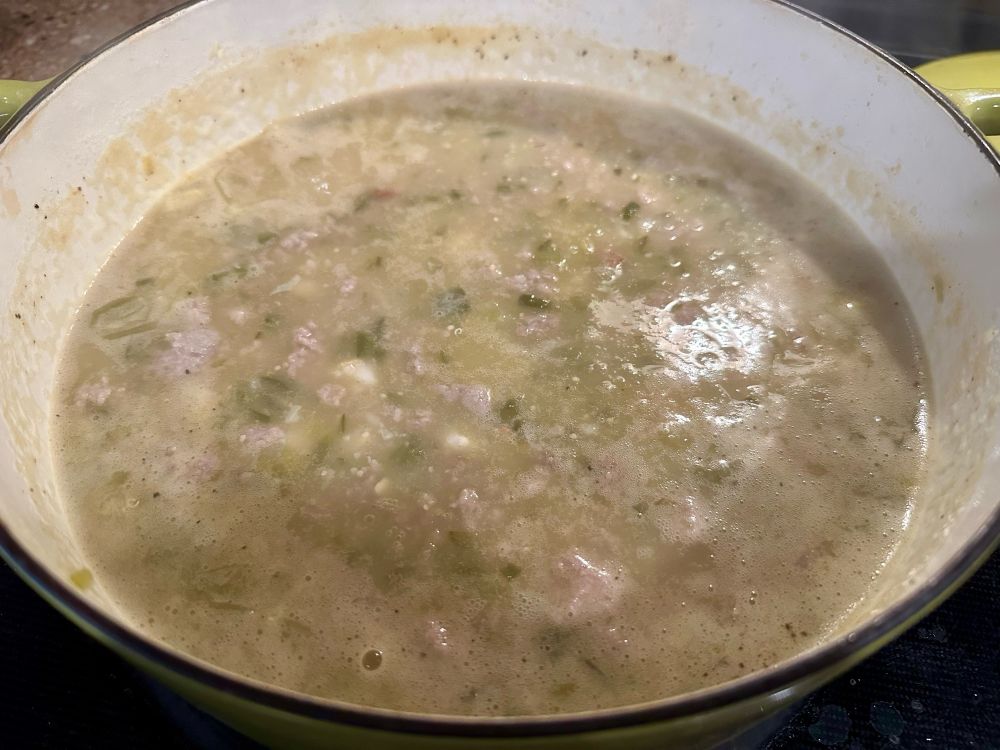 Crockpot with hominy chili simmering in it.