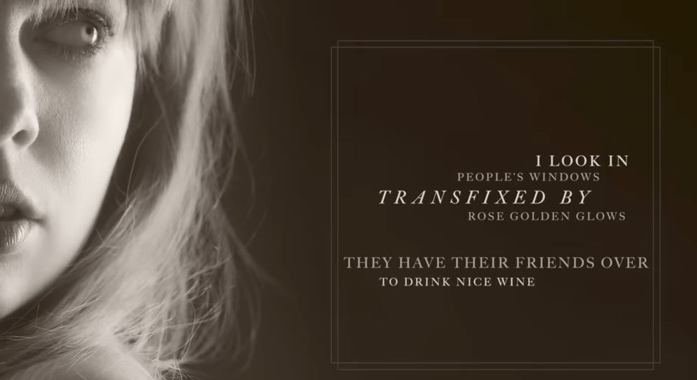 A screenshot from the lyric video for ‘I Look in People’s Windows’, featuring the lyrics — “I look in people’s windows, transfixed by rose-golden glows, they have their friends over to drink nice wine.” 