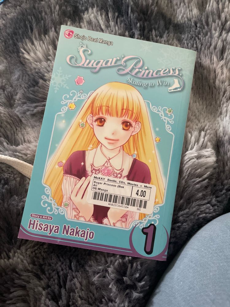 Manga with a light blue cover and blonde girl called “Sugar Princess: skating to win” vol 1