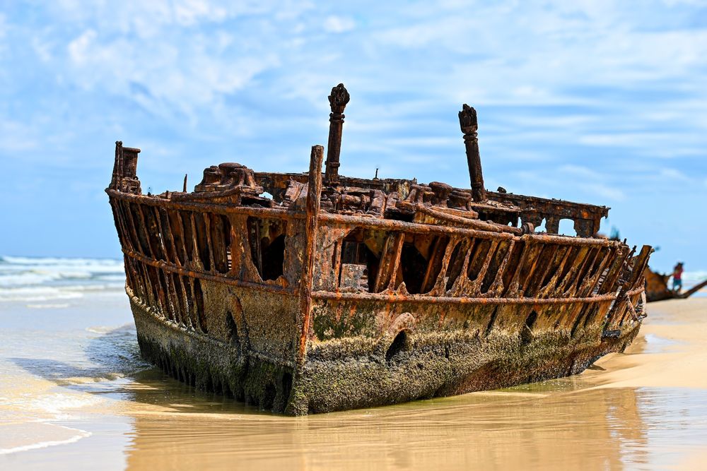 The Fraser Island shipwreck refers to the remains of the SS Maheno, a former luxury ocean liner that ran aground on Fraser Island, Australia, in 1935. The vessel, originally launched in 1905, was en route to Japan for scrap metal when it encountered rough seas and was stranded on the island's shores. Today, the wreck is a popular tourist attraction and is notable for its historic and photographic appeal, with the rusted hull partially submerged in the sand and surrounded by the stunning natural beauty of the island. Fraser Island, a UNESCO World Heritage site, showcases a unique landscape of rainforests, dunes, and diverse wildlife, making the shipwreck an intriguing part of its history.