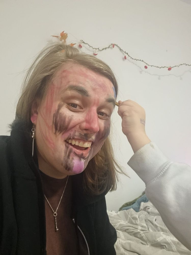 Valerie is getting her already quite wildly painted face painted even more.