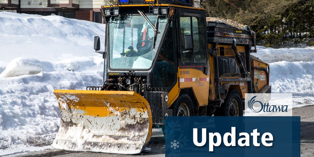 A City of Ottawa sidewalk plow with sand in the back is driving down the side of the road. A blue text box is in the bottom righthand corner with white text that reads "update"