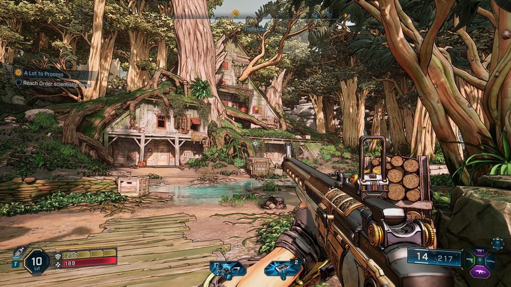 Screenshot aus Borderlands 4, Ego Perspektive, ins Bild ragt eine Waffe an Wild-West-Repetiergewehre angelehnt und schaut in einem dichten, durchleuchteten Wald auf ein Haus, das ins Wurzelwerk eines großen Baumes integriert wurde