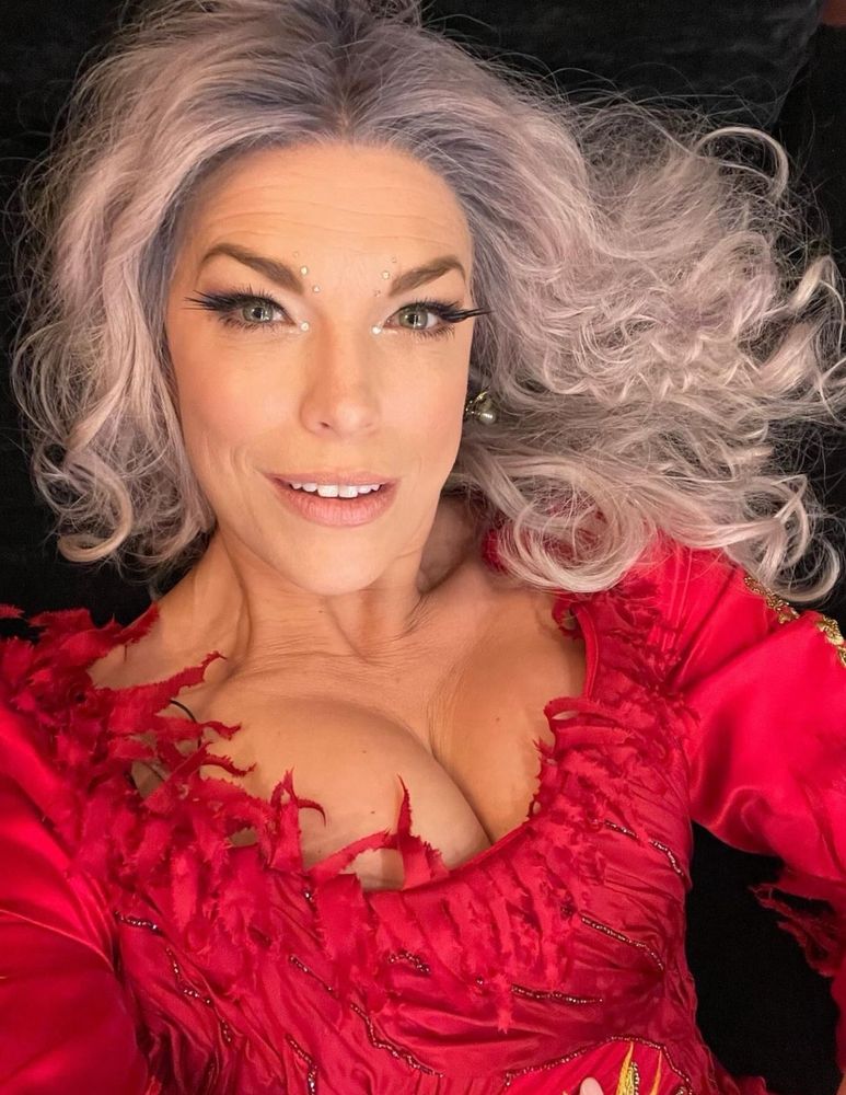 Hannah Waddingham selfie in her Hocus Pocus 2 red witch costume and silvery wig. 