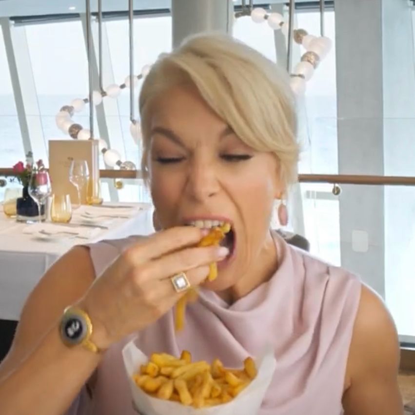 hannah waddingham shoving french fries  in  to her mouth 