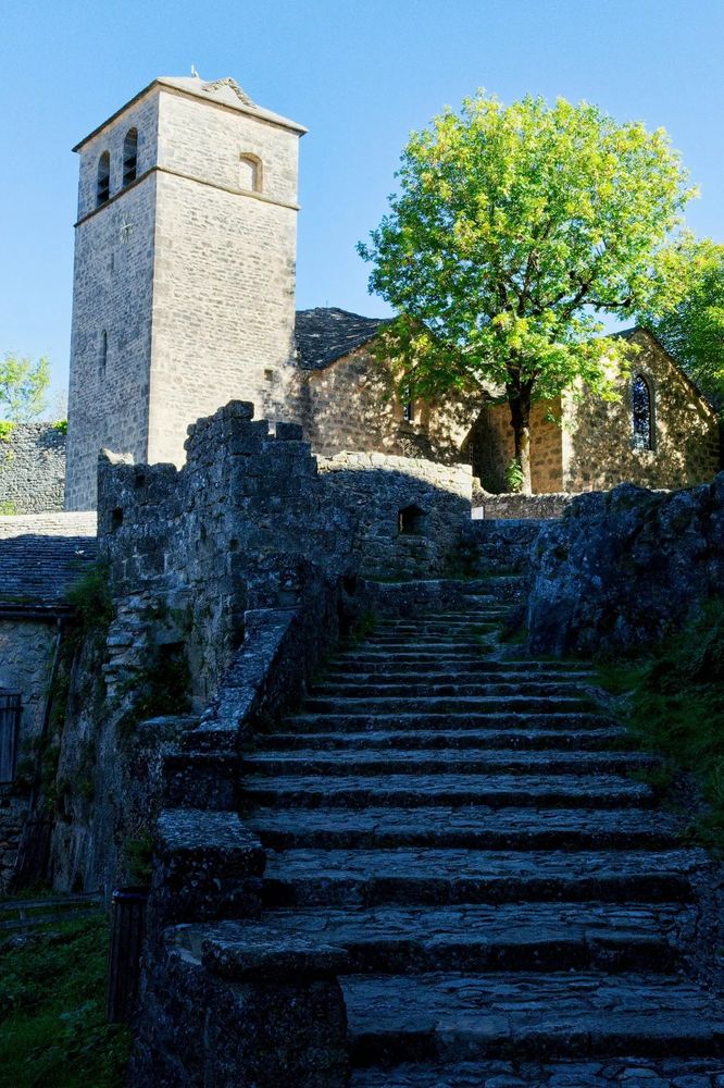 Medieval stone tower standing tall against the sky, reflecting history, heritage and the romance of French villages